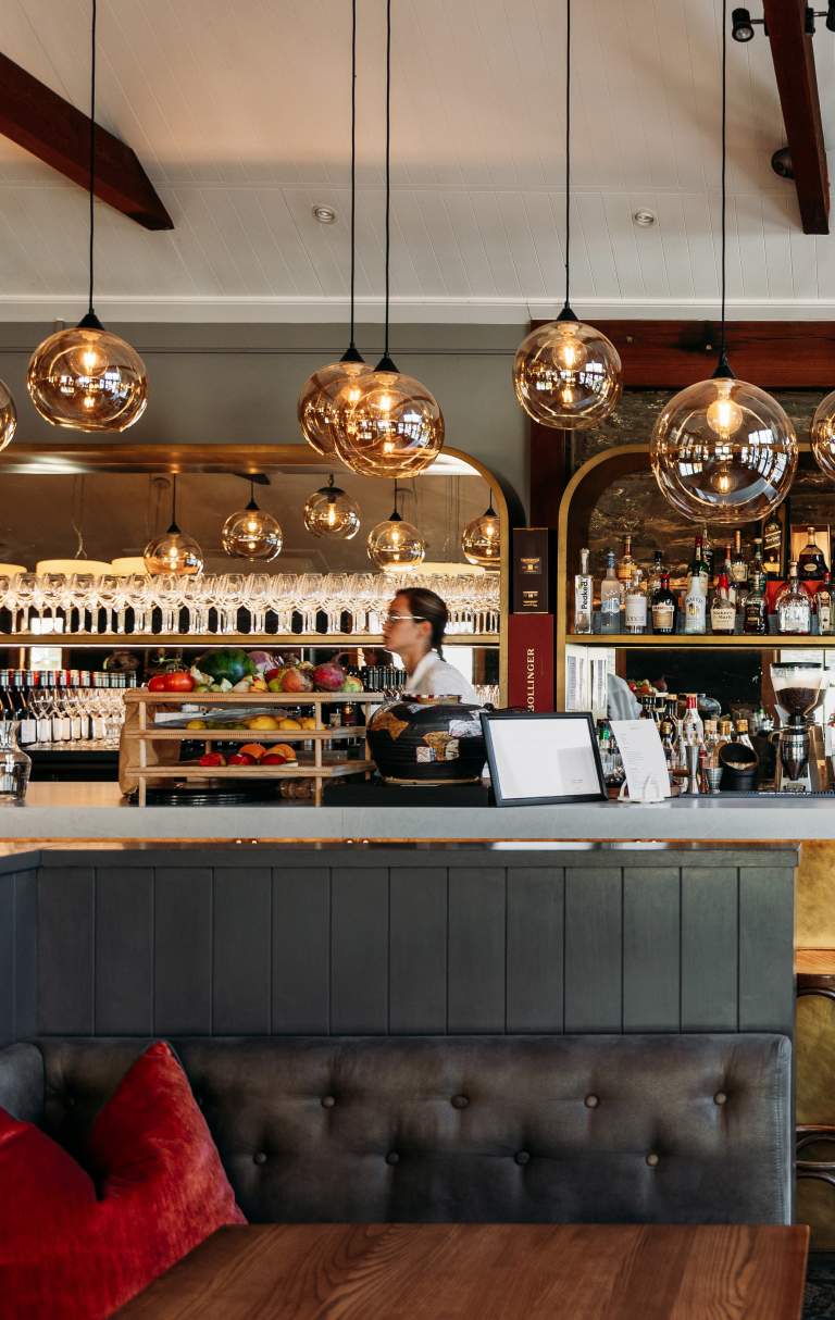 Interior shot of Aosta Restaurant - modern design with liquor bottles in the background