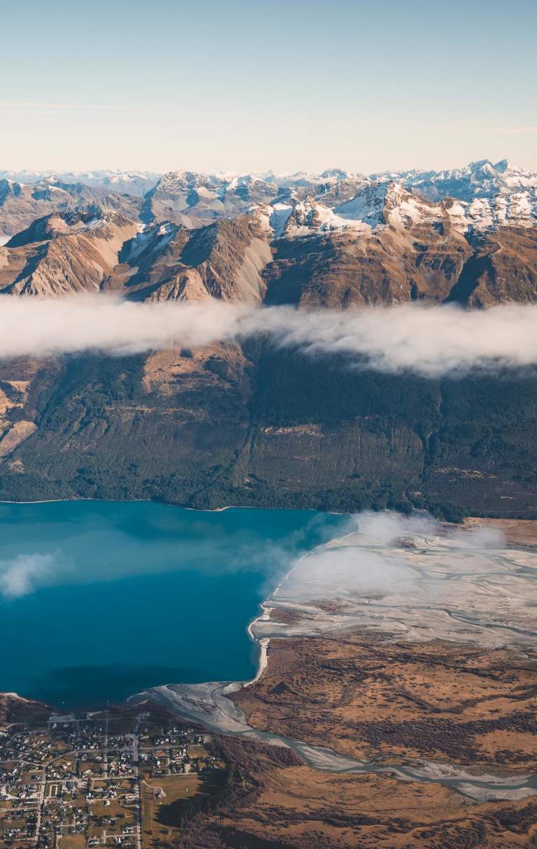 Aerial photo of Glenorchy township with huge mountains in the background