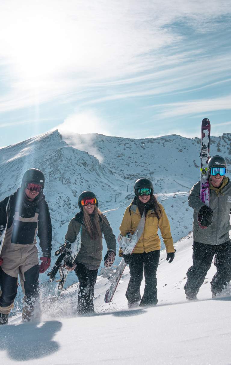 Four people walking up mountain at the Remarkables Ski Area
