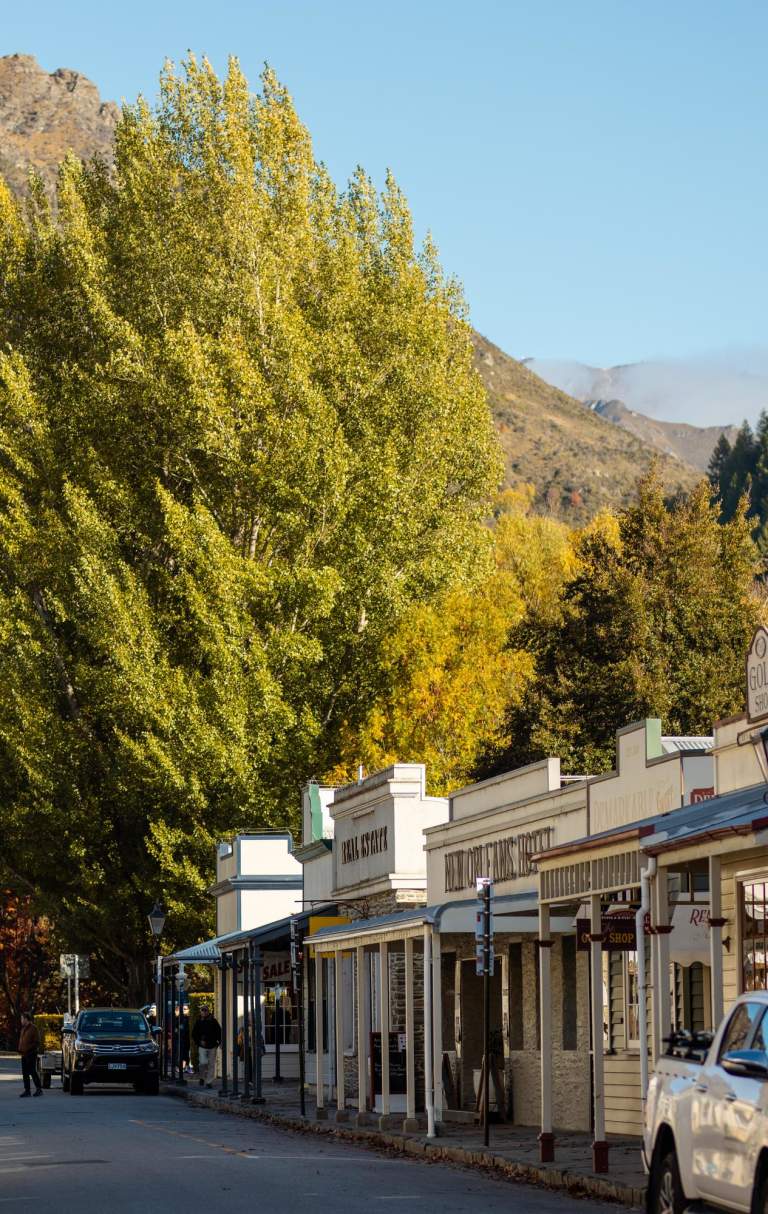 Street lined with old buildings and boutique shops in Arrowtown