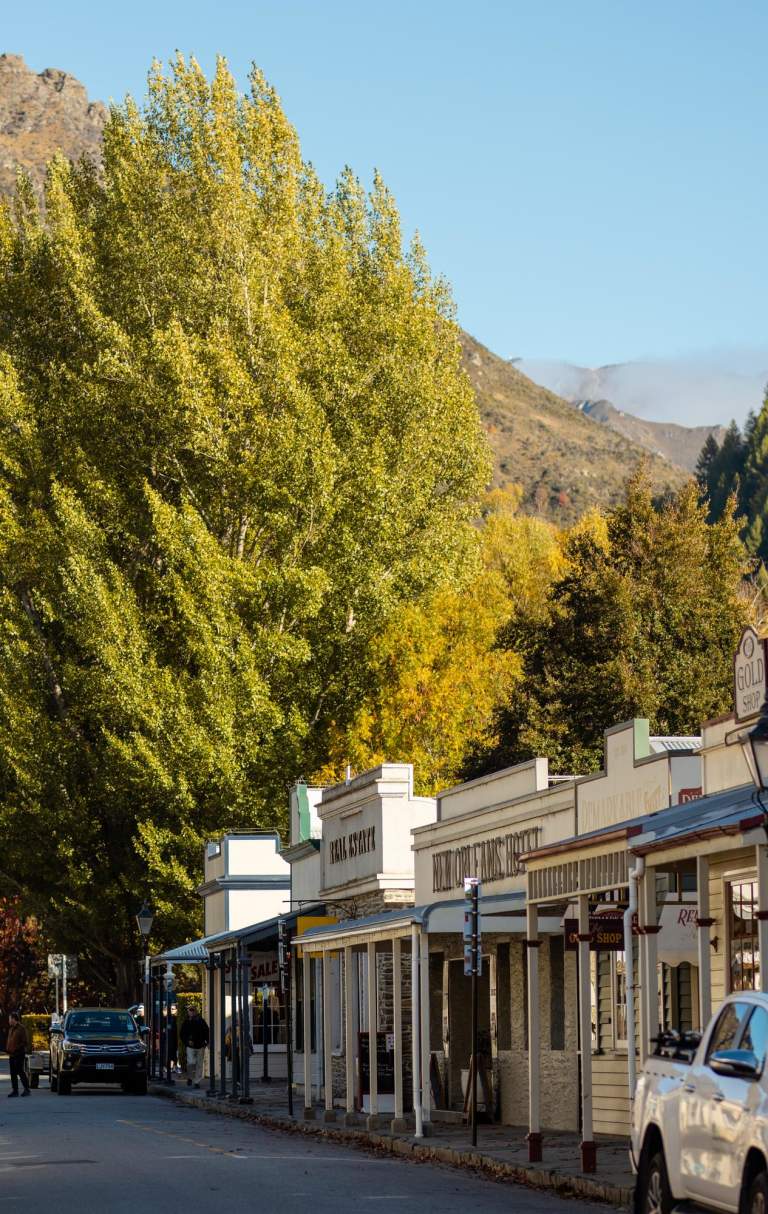 Street lined with old buildings and boutique shops in Arrowtown