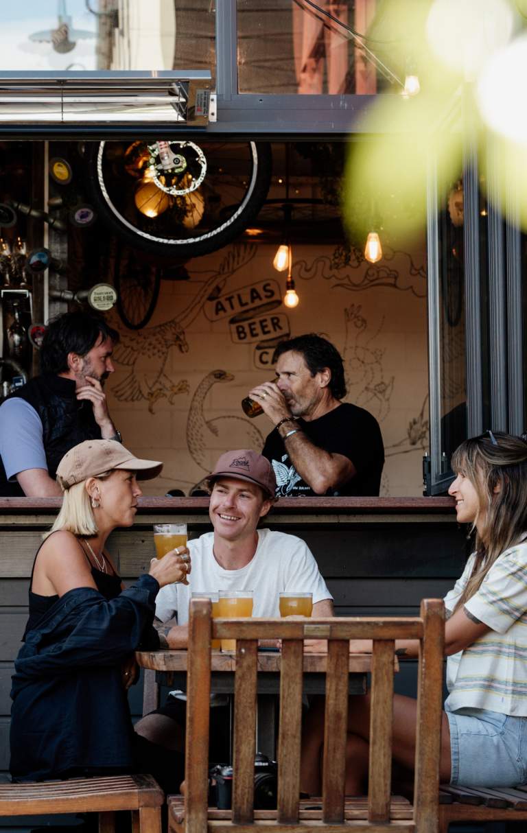Friends enjoying a pint of beer at Atlas Beer Cafe in Queenstown