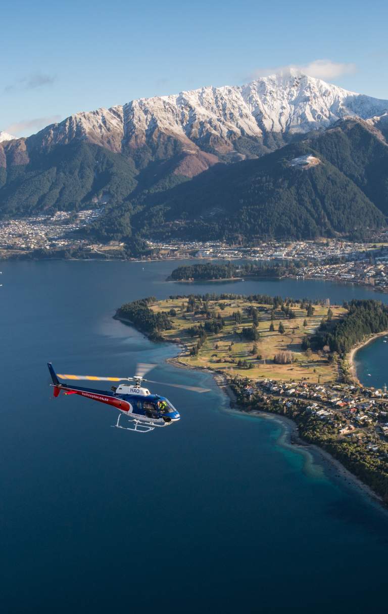 Helicopter flying over Queenstown Lake