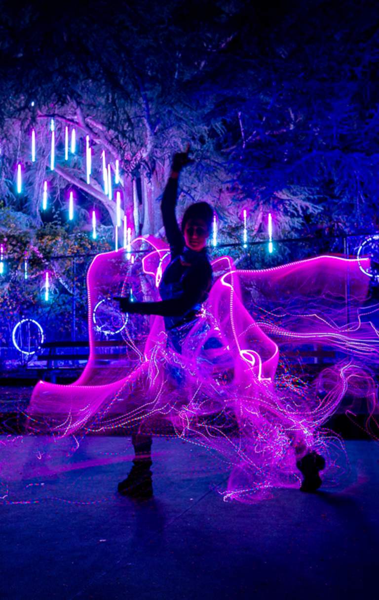 Person in a light up costume at night