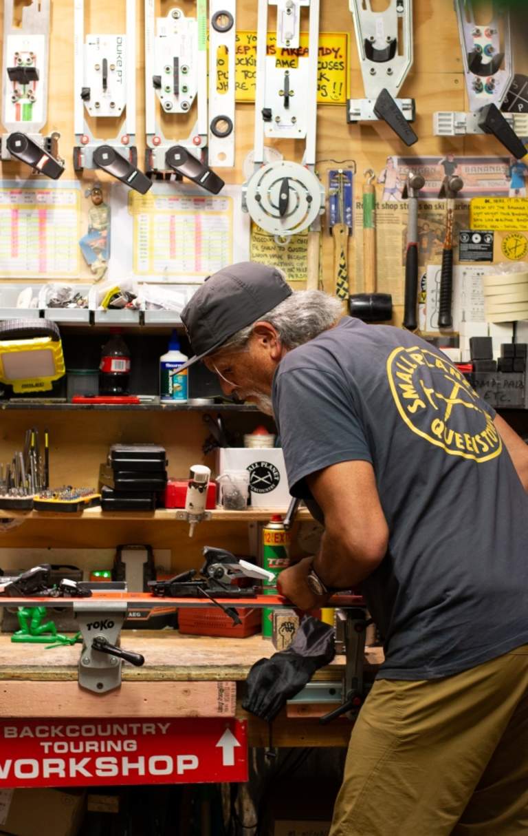 Darryl Tatom, Owner of Small Planet in workshop surrounded by sporting gear