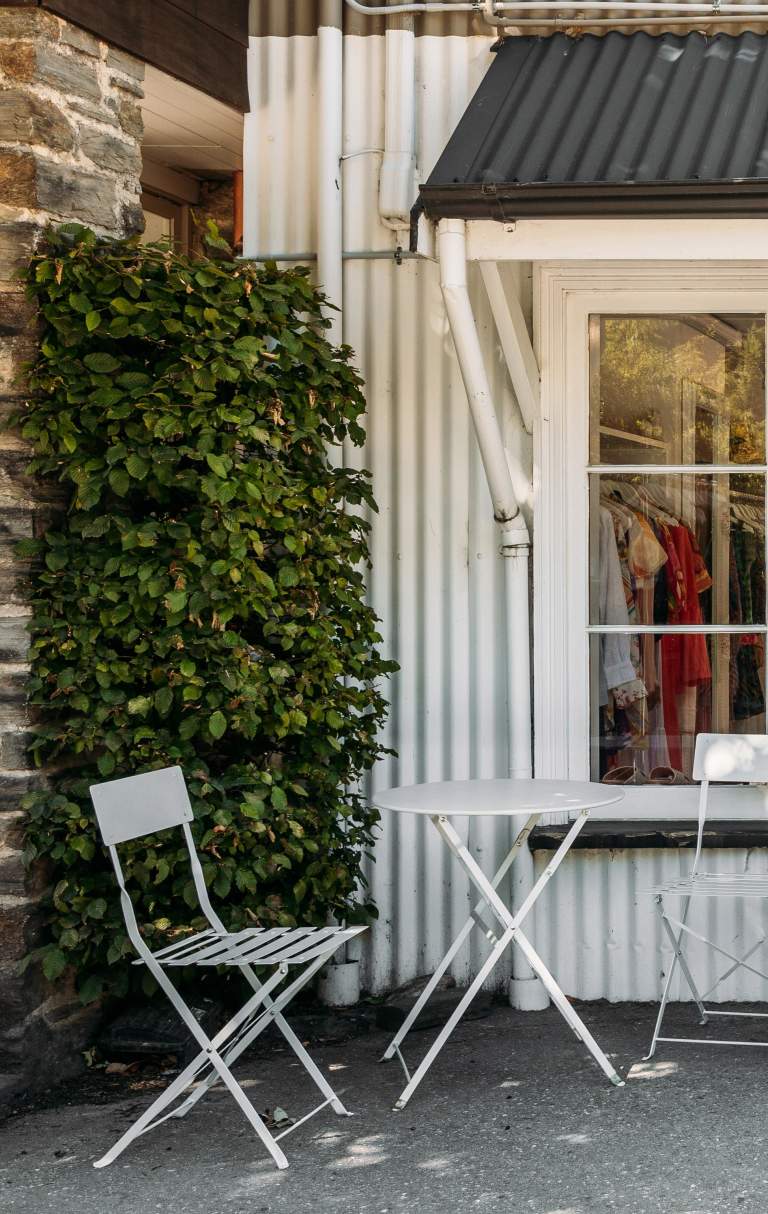 Outside view of a a white, cottage-style looking boutique shop