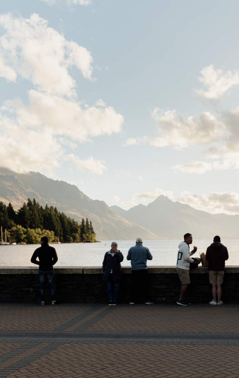 Queenstown Bay at dusk with mountains in the background