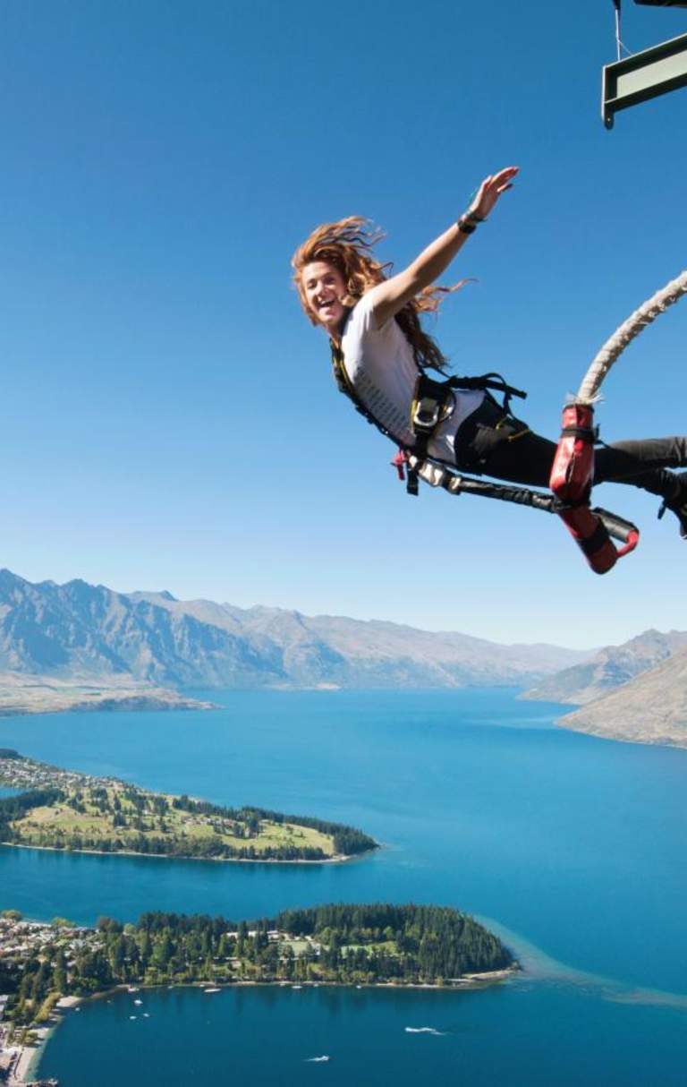 Woman bungy jumping in Queenstown at the AJ Hackett Ledge Bungy