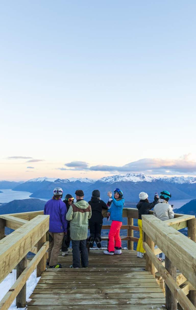 Group of people sightseeing at viewpoint atop of a mountain
