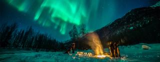 Travelers camp out to catch the northern lights near Anchorage.