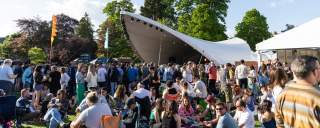 Crowds in the Festival Village at Cheltenham Jazz Festival, Montpellier Gardens, Cheltenham.