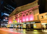 Exterior of Manchester Opera House at night with pink lighting