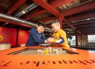 Two children playing with exhibit at Science and Industry Museum