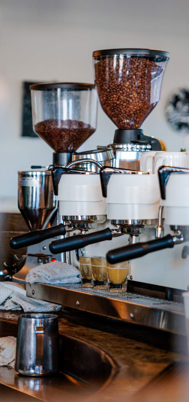 An espresso machine filled with coffee beans ready to grind
