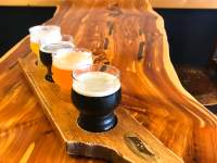 flight of four beers in a wooden cutout of TN