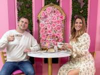 couple enjoying tea in a bright pink tearoom