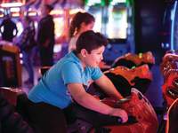 boy playing in an arcade