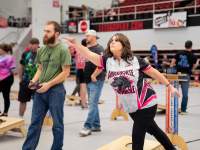 lady and man playing cornhole