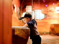 boy in bubble cave at Customs House Museum