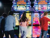 people playing arcade games