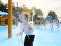 boy playing in a plash pad