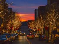 Christmas lights on a street at sunset