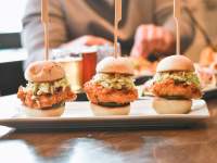 chicken sliders with people eating in the background