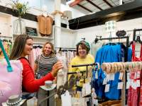 three ladies shopping in a boutique