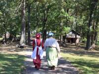 two women walk in period clothing