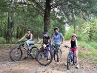 family on bikes in wooded trail