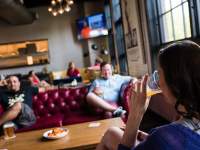 three people  hanging out in a pub