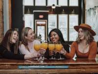 girls drinking mimosas at bar