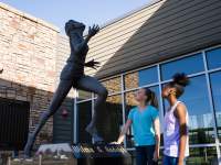 two girls admire the Wilma Rudolph statue
