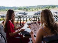 two ladies dining overlooking a marina