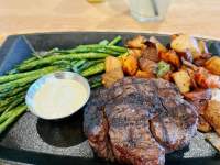 a steak, potatoes and asparagus on a platter