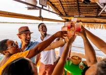 Friends toasting aboard the Oasis Tiki Boat in Charlotte Harbor, Florida