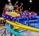 family on an indoor roller coaster
