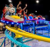 family on an indoor roller coaster