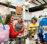 three ladies shopping in a boutique
