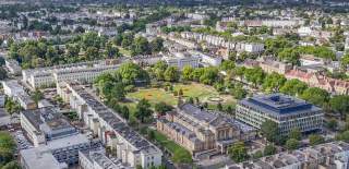 Aerial view of Cheltenham Town Hall and Imperial Gardens, Cheltenham and surrounding areas of the town.