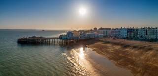 Photograph by Shaun Roster showing the Southsea Beach and South Parade Pier as the sun begins to set behind it.
