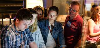 A group of people looks at an exhibit at The D-Day Story in Portsmouth