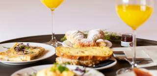 Breakfast items laid out on a bed