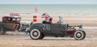 A vintage car roaring across Bridlington's South Beach in East Yorkshire as part of the Race the Waves event