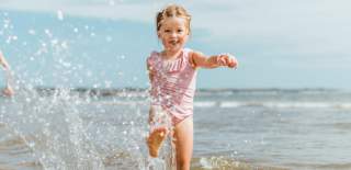 A little girl splashing in the sea at Bridlington in East Yorkshire