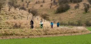 Group cycling along a country road in the Yorkshire Wolds