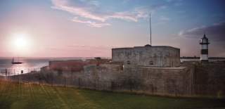 Photograph showing Southsea Castle with a pink-hued sunset behind