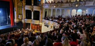 An audience at the New Theatre Royal watches a performance