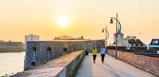 Photograph of two people walking on the fortifications of Old Portsmouth