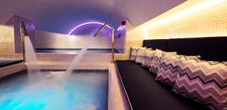 Underground swimming pool with water jets and seating at HarSpa at Harbour House Hotel